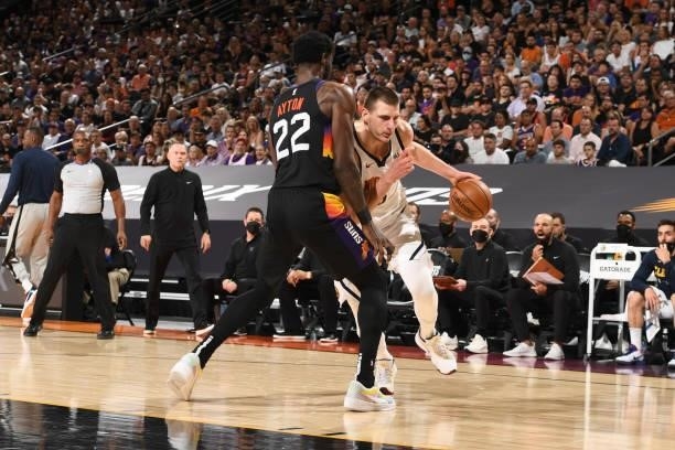 Deandre Ayton of the Phoenix Suns plays defense on Nikola Jokic of the Denver Nuggets during Round 2, Game 1 of the 2021 NBA Playoffs on June 7, 2021...
