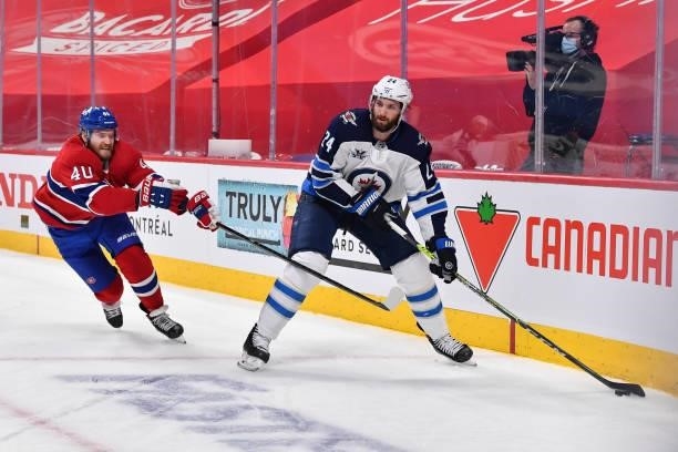 Derek Forbort of the Winnipeg Jets skates the puck against Joel Armia of the Montreal Canadiens during the second period in Game Four of the Second...