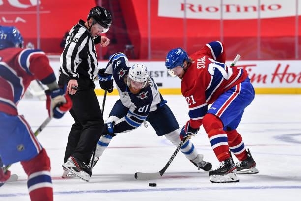 Eric Staal of the Montreal Canadiens wins the draw against Kyle Connor of the Winnipeg Jets during the third period in Game Four of the Second Round...