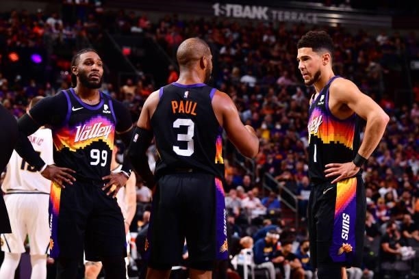 Chris Paul talks to Devin Booker and Jae Crowder of the Phoenix Suns during Round 2, Game 1 of the 2021 NBA Playoffs on June 7, 2021 at Phoenix Suns...
