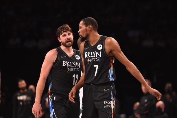 Joe Harris of the Brooklyn Nets and Kevin Durant of the Brooklyn Nets react during a game against the Milwaukee Bucks during Round 2, Game 2 on June...
