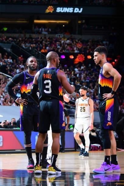 Chris Paul of the Phoenix Suns talks to teammates Jae Crowder and Devin Booker during the game against the Denver Nuggets during Round 2, Game 1 of...