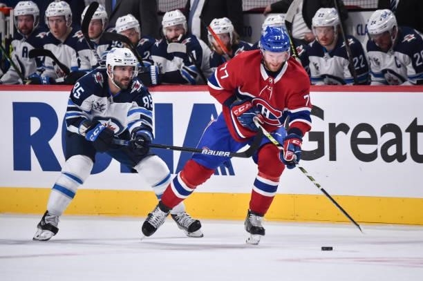 Mathieu Perreault of the Winnipeg Jets challenges Brett Kulak of the Montreal Canadiens during the third period in Game Four of the Second Round of...