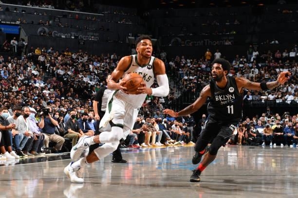 Giannis Antetokounmpo of the Milwaukee Bucks drives to the basket against Kyrie Irving of the Brooklyn Nets during Round 2, Game 2 on June 7, 2021 at...