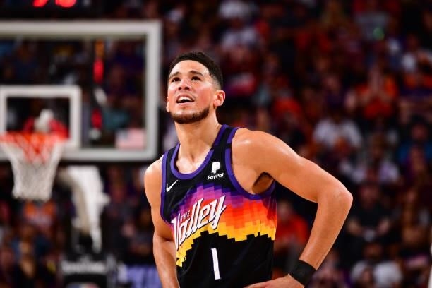 Devin Booker of the Phoenix Suns looks on during Round 2, Game 1 of the 2021 NBA Playoffs on June 7, 2021 at Phoenix Suns Arena in Phoenix, Arizona....