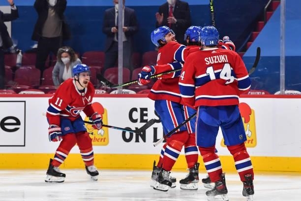 Tyler Toffoli of the Montreal Canadiens celebrates his overtime goal with teammates Ben Chiarot, Nick Suzuki and Brendan Gallagher against the...