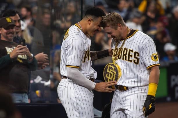 Manny Machado places the 'swag chain' on Brian O'Grady of the San Diego Padres after O'Grady's home run in the third inning against the Chicago Cubs...