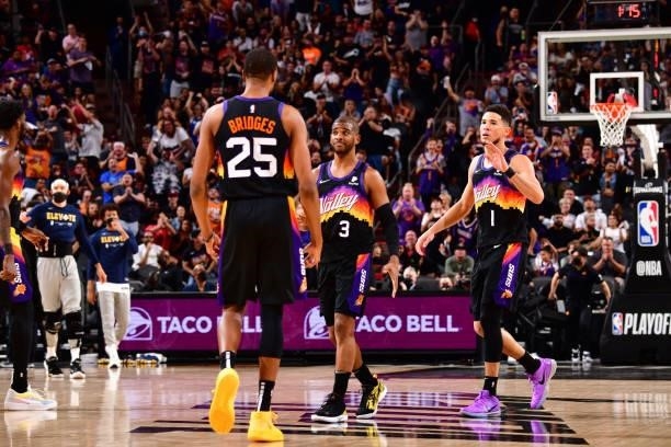 Mikal Bridges celebrates with Chris Paul and Devin Booker of the Phoenix Suns during Round 2, Game 1 of the 2021 NBA Playoffs on June 7, 2021 at...