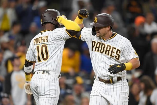 Brian O'Grady of the San Diego Padres is congratulated by Jurickson Profar of the after hitting a two-run home run during the third inning of a...