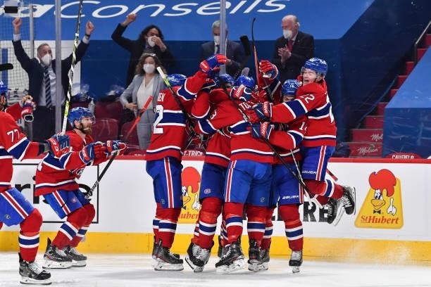 The Montreal Canadiens celebrate an overtime victory against the Winnipeg Jets in Game Four of the Second Round of the 2021 Stanley Cup Playoffs at...