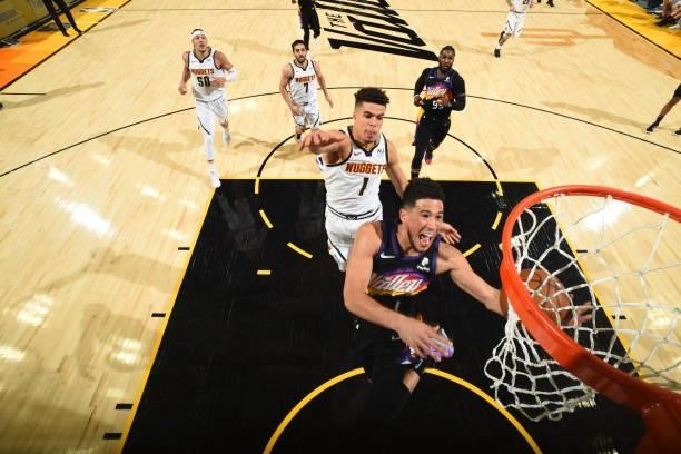 Devin Booker of the Phoenix Suns drives to the basket during Round 2, Game 1 of the 2021 NBA Playoffs on June 7, 2021 at Phoenix Suns Arena in...
