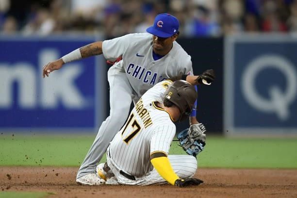 Victor Caratini of the San Diego Padres slides into second base ahead of the tag of Sergio Alcantara of the Chicago Cubs during the second inning of...