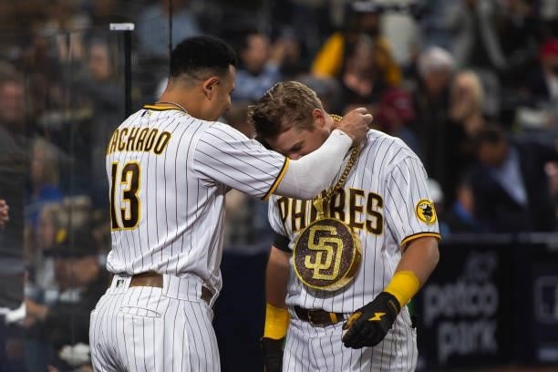Manny Machado places the 'swag chain' on Brian O'Grady of the San Diego Padres after O'Grady's home run in the third inning against the Chicago Cubs...