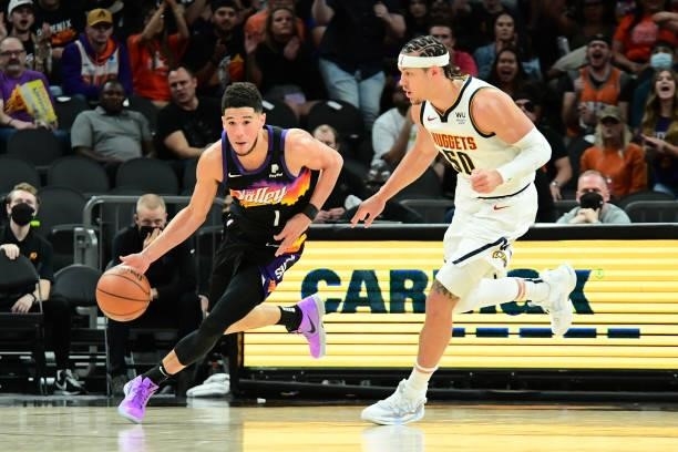 Devin Booker of the Phoenix Suns dribbles the ball during the game against the Denver Nuggets during Round 2, Game 1 of the 2021 NBA Playoffs on June...