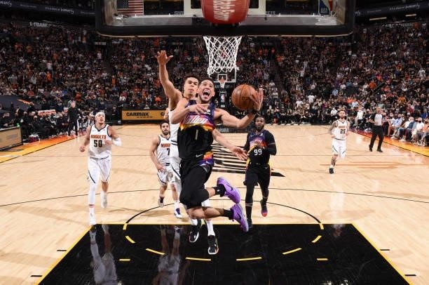 Devin Booker of the Phoenix Suns drives to the basket during Round 2, Game 1 of the 2021 NBA Playoffs on June 7, 2021 at Phoenix Suns Arena in...