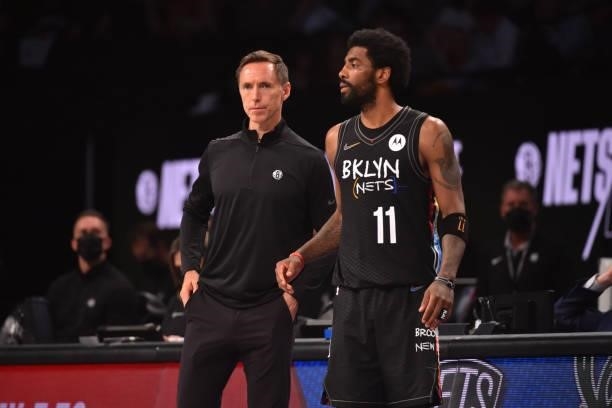 Head Coach Steve Nash of the Brooklyn Nets and Kyrie Irving of the Brooklyn Nets look on during a game against the Milwaukee Bucks during Round 2,...