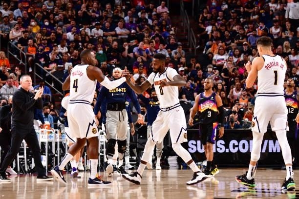 Paul Millsap and JaMychal Green of the Denver Nuggets shake hands during Round 2, Game 1 of the 2021 NBA Playoffs on June 7, 2021 at Phoenix Suns...