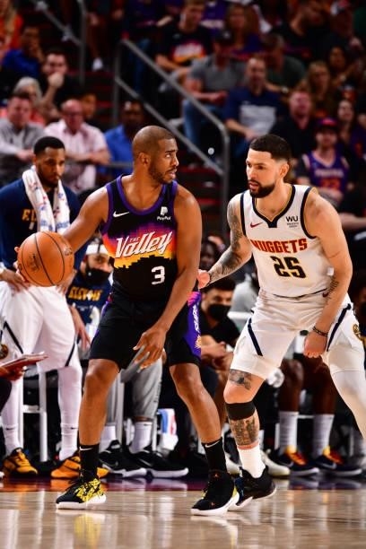 Austin Rivers of the Denver Nuggets plays defense on Chris Paul of the Phoenix Suns during Round 2, Game 1 of the 2021 NBA Playoffs on June 7, 2021...