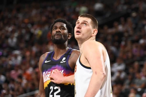 Deandre Ayton of the Phoenix Suns and Nikola Jokic of the Denver Nuggets look on during Round 2, Game 1 of the 2021 NBA Playoffs on June 7, 2021 at...