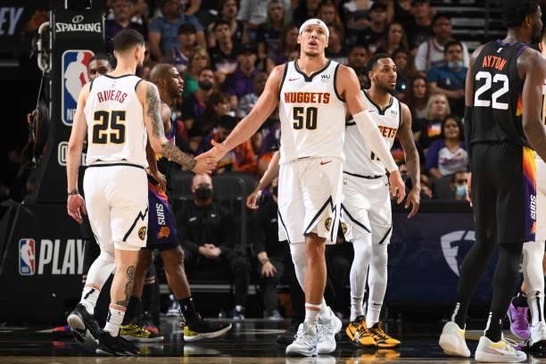 Austin Rivers hi-fives Aaron Gordon of the Denver Nuggets during Round 2, Game 1 of the 2021 NBA Playoffs on June 7, 2021 at Phoenix Suns Arena in...