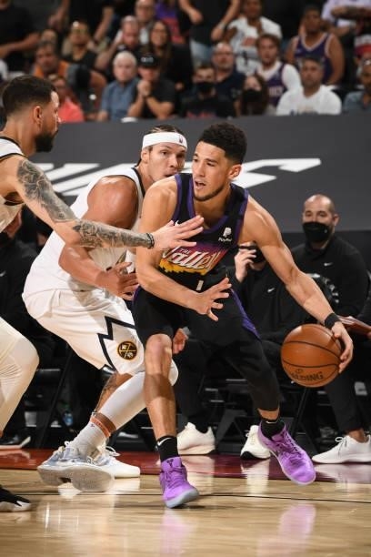 Aaron Gordon of the Denver Nuggets plays defense on Devin Booker of the Phoenix Suns during Round 2, Game 1 of the 2021 NBA Playoffs on June 7, 2021...