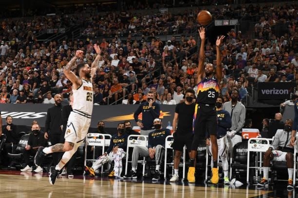 Mikal Bridges of the Phoenix Suns shoots a three point basket during Round 2, Game 1 of the 2021 NBA Playoffs on June 7, 2021 at Phoenix Suns Arena...