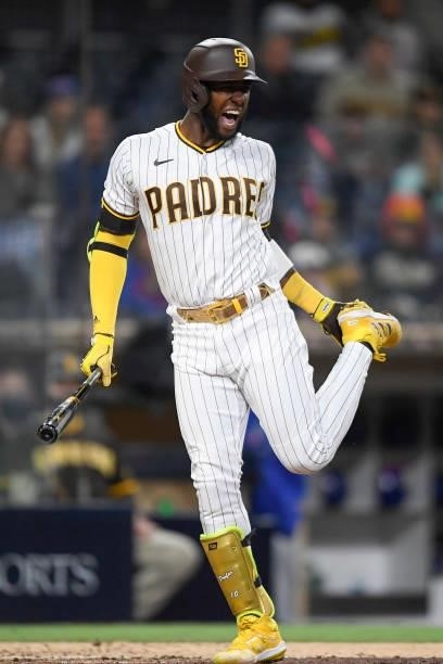 Jurickson Profar of the San Diego Padres grimaces after being hit with a pitch during the seventh inning of a baseball game against the Chicago Cubs...