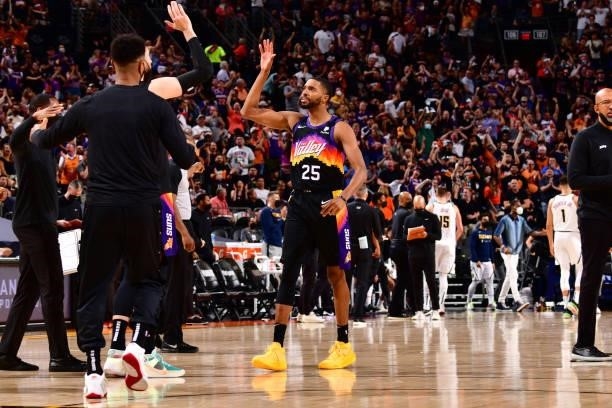 Mikal Bridges of the Phoenix Suns high fives a teammate during Round 2, Game 1 of the 2021 NBA Playoffs on June 7, 2021 at Phoenix Suns Arena in...