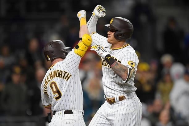 Manny Machado of the San Diego Padres, right, is congratulated by Jake Cronenworth after hitting a solo home run during the eighth inning of a...
