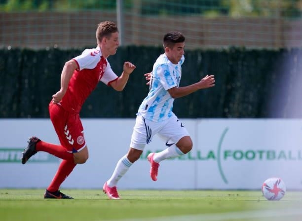 Thiago Almada of Argentina Under-23 and Jacob Steen Christensen of Denmark Under-21 battle for the ball during the international friendly match...
