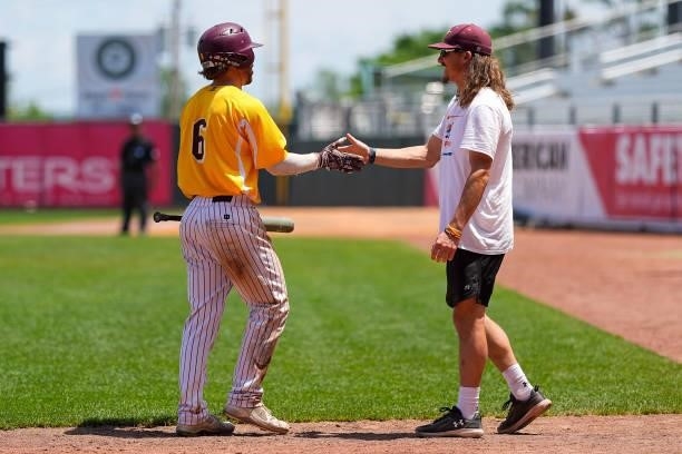 Stephen Rice of Salisbury is congratulated by teammate Jimmy Adkins after scoring a run against St. Thomas during the Division III Men's Baseball...