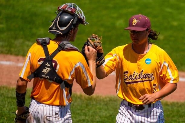 Corey Burton of Salisbury is congratulated by teammate Jacob Ference against St. Thomas during the Division III Men's Baseball Championship held at...