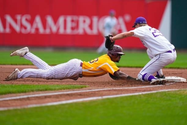 Kavi Caster of Salisbury dives back safe to first against Max Moris of St Thomas during the Division III Men's Baseball Championship held at Perfect...