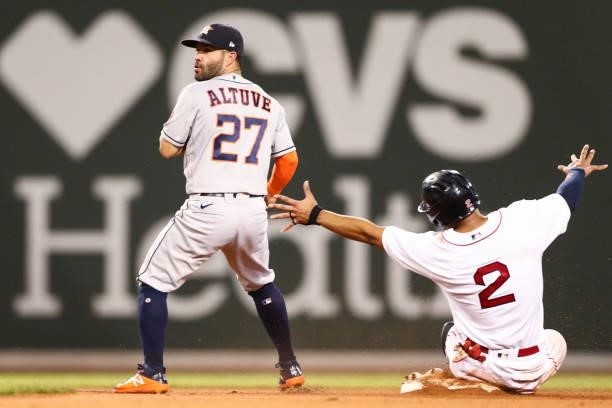 Jose Altuve of the Houston Astros looks to turn the double play as Xander Bogaerts of the Boston Red Sox slides into second base in the fifth inning...