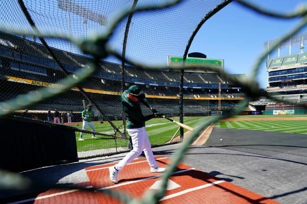 Mark Canha of the Oakland Athletics takes batting practice prior to the game between the Arizona Diamondbacks and the Oakland Athletics at Oakland...