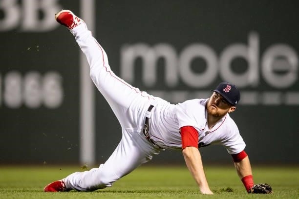 Christian Arroyo of the Boston Red Sox falls as he throws during the seventh inning of a game against the Houston Astros on June 8, 2021 at Fenway...