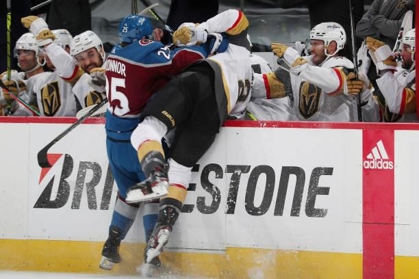 Logan O'Connor of the Colorado Avalanche checks Zach Whitecloud of the Vegas Golden Knights into his own bench in Game Five of the Second Round of...
