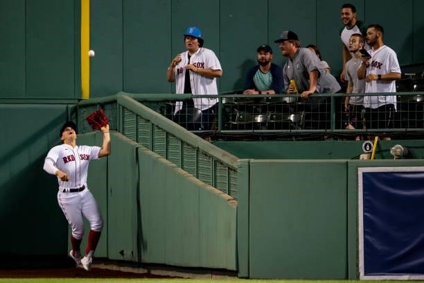 Enrique Hernandez of the Boston Red Sox catches a fly ball during the ninth inning of a game against the Houston Astros on June 8, 2021 at Fenway...