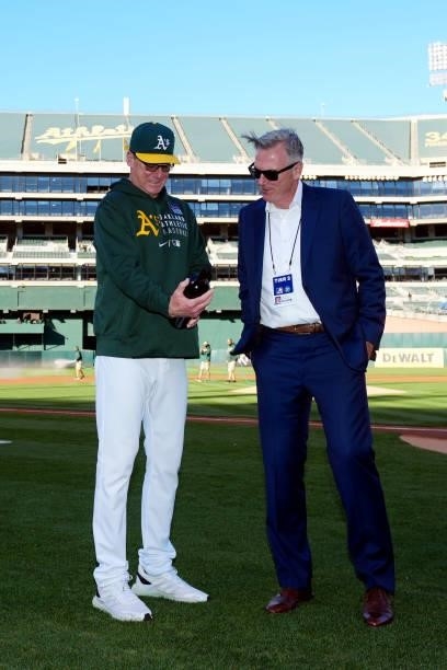 Executive Vice President of Baseball Operations of the Oakland Athletics Billy Bean presents Manager Bob Melvin a bottle of wine for his work with...