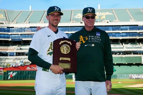 Manager Bob Melvin of the Oakland Athletics presents Stephen Piscotty a Lou Gehrig plaque for his work with 4ALS on Lou Gehrig Day prior to the game...