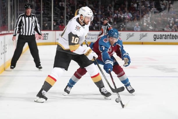Devon Toews of the Colorado Avalanche poke checks the puck away from Nicolas Roy of the Vegas Golden Knights in Game Five of the Second Round of the...