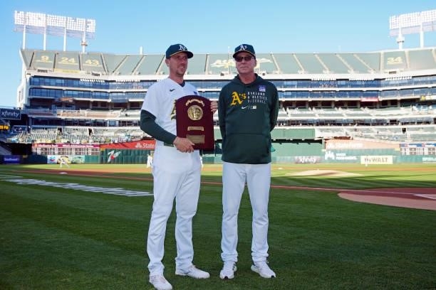 Manager Bob Melvin of the Oakland Athletics presents Stephen Piscotty a Lou Gehrig plaque for his work with 4ALS on Lou Gehrig Day prior to the game...