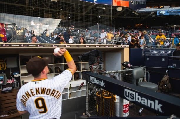 Jake Cronenworth of the San Diego Padres tosses a ball to a fan before facing the Chicago Cubs at Petco Park on June 8, 2021 in San Diego, California.
