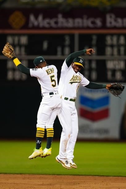 Tony Kemp of the Oakland Athletics celebrates with Elvis Andrus after the game between the Arizona Diamondbacks and the Oakland Athletics at Oakland...