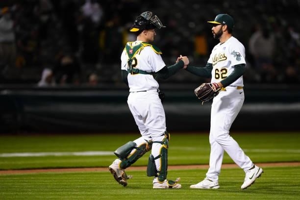 Sean Murphy of the Oakland Athletics celebrates with Lou Trivino after the game between the Arizona Diamondbacks and the Oakland Athletics at Oakland...