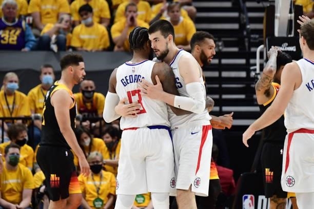 Paul George hugs Ivica Zubac of the LA Clippers during Round 2, Game 1 of the 2021 NBA Playoffs on June 8, 2021 at vivint.SmartHome Arena in Salt...