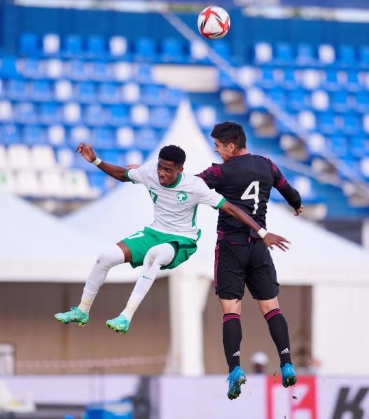 Jesus Ricardo Angulo of Mexico Under-23 and Saad Al Salouli of Saudi Arabia Under-23 battle for the ball during the international friendly match...