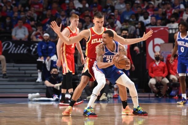 George Hill of the Philadelphia 76ers handles the ball against Bogdan Bogdanovic of the Atlanta Hawks during Round 2, Game 2 of the Eastern...