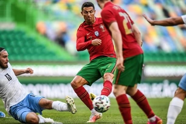 Portugal's forward Cristiano Ronaldo is tackled by Israel's defender Ofri Arad during the international friendly football match between Portugal and...