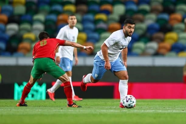 Osama Khalaila of Israel and Bnei Sakhnin tries to escape Joao Moutinho of Portugal and Wolverhampton during the international friendly match between...